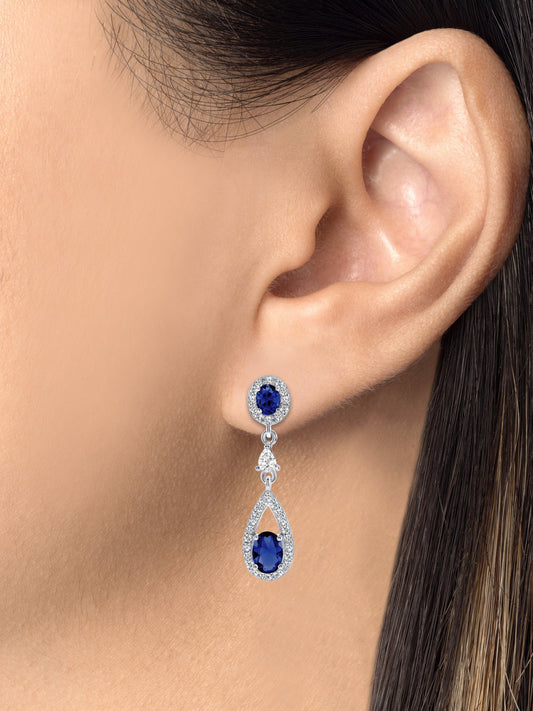 Silver 925 Rhodium Plated Dangling Blue Cubic Zirconia Earrings. DGE1008BLU